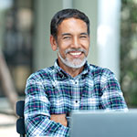 Portrait of happy mature man with white, grey stylish short beard looking at camera outdoor. Casual lifestyle of retired hispanic people or adult asian man smile with confident at coffee shop cafe.